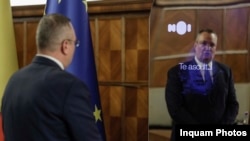Romanian Prime Minister Nicolae Ciuca speaks to political adviser Ion (John in English) at its unveiling on March 1.