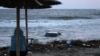 A woman looks at a car floating in the sea in the town of Tsarevo, on Bulgaria&#39;s Black Sea coast. on September 6.<br />
<br />
At least two men have died, and a search for a mother and child continues following <a href="https://d248ijkgwbbf5u.cloudfront.net/a/dvama-muzhe-zaginali-pri-navodneniata-carevo/32580506.html" target="_self">torrential rains</a> that caused widespread flooding in the region.