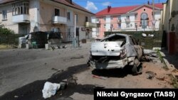 Buildings and a vehicle damaged from attacks in Shebekino earlier this month.