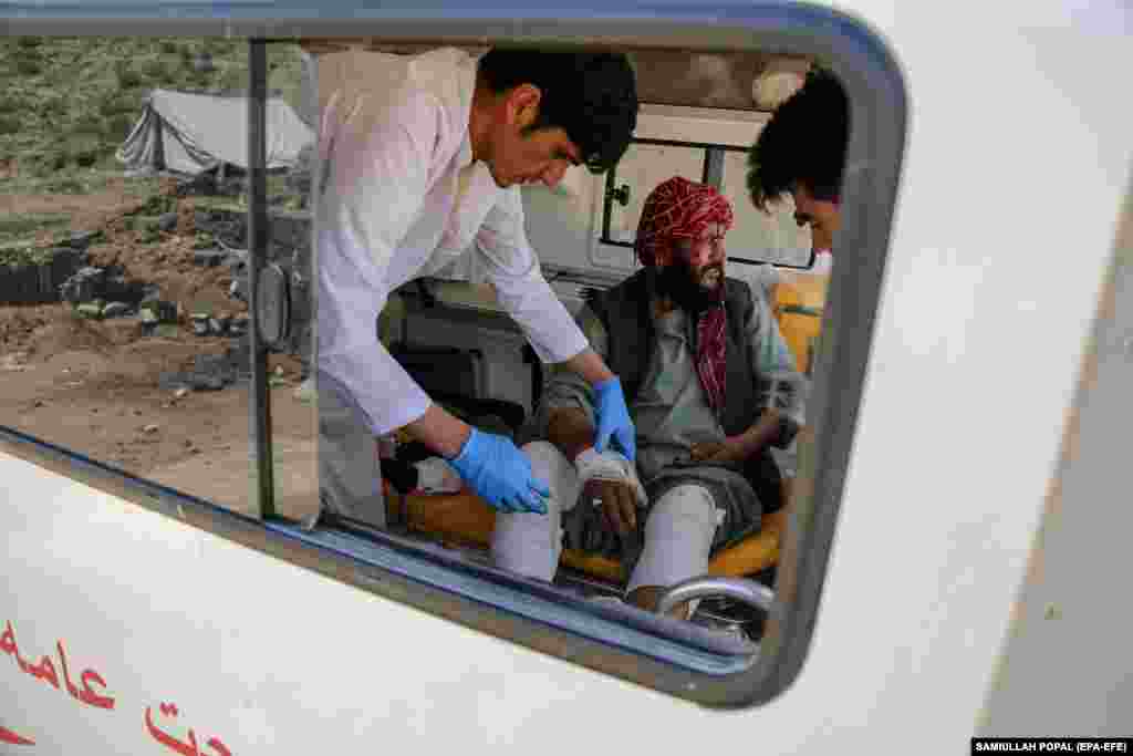 Haji Sarakha, a 48-year-old Afghan man who lost all of his family members in floods, receives treatment inside an ambulance. 