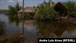 A flooded cottage in the village of Odradokamyanka that had earlier been damaged by shelling.