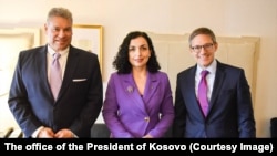 The U.S. special envoy for the Western Balkans, Gabriel Escobar (left), and State Department Counselor Derek Chollet (right) -- pictured here with Kosovar President Vjosa Osmani -- are expected in Pristina on December 12. (file photo)