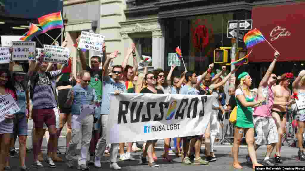 As the parade began, organizer Yelena Goltsman gathered the group and shouted, "Let's show 'em the Russian are coming! They're here!"