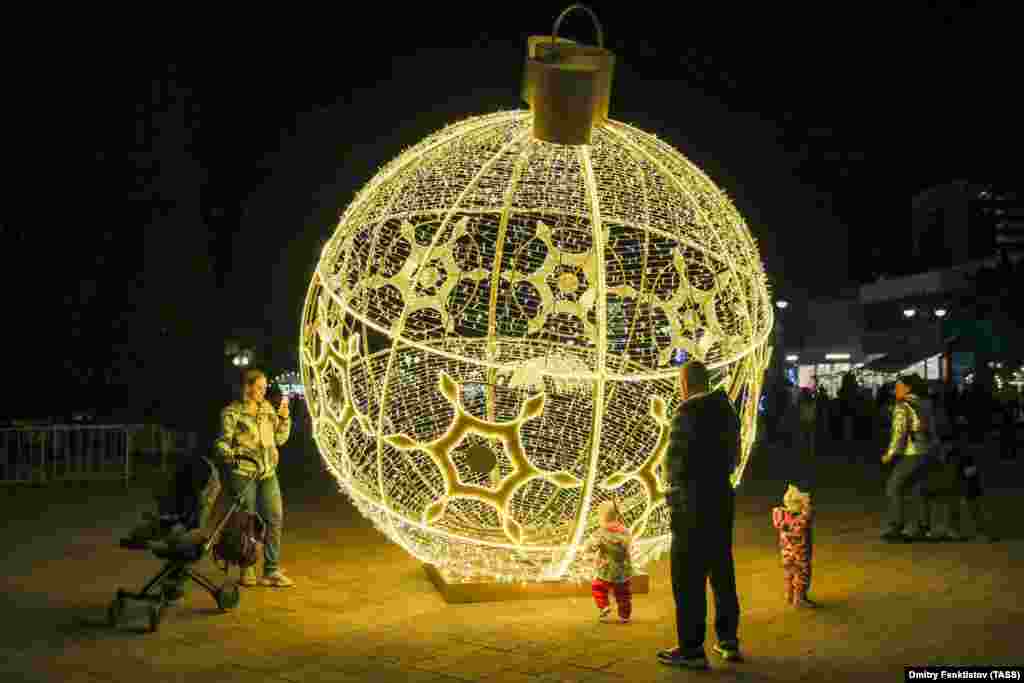 An oversized Christmas bauble lights up a street in Sochi.
