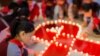 CHINA - Students use candles to form a large ribbon during an event to mark World AIDS Day at a primary school in Hohhot, Inner Mongolia autonomous region, China December 1, 2017