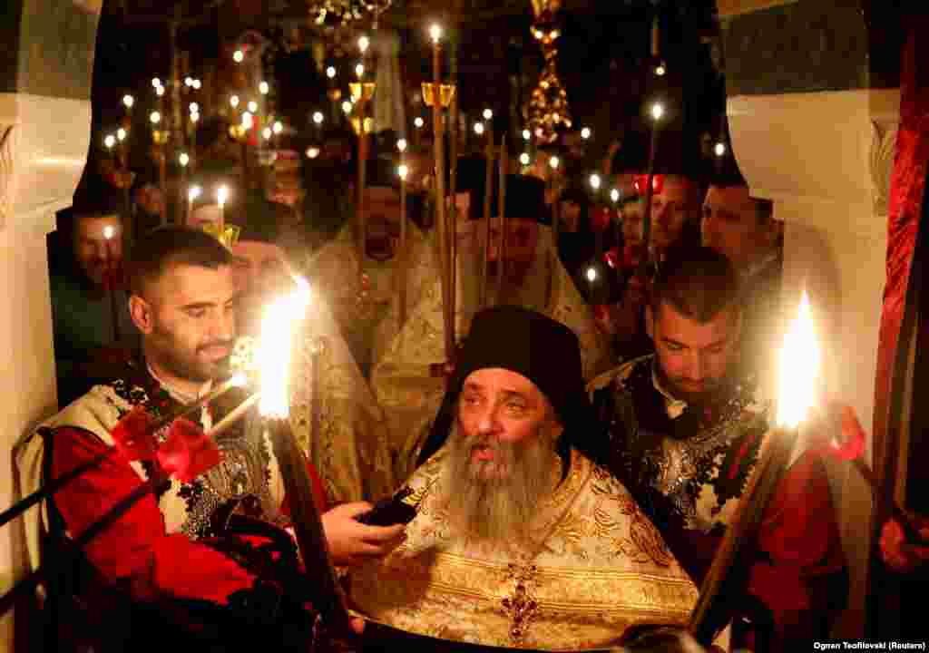 Archimandrite Partenie attends Orthodox Easter services at St. John the Baptist Monastery near Mavroro,&nbsp;North Macedonia, as the service is streamed online on April 18.