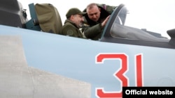 In a photo released by his press service on December 27, 2019, Armenian Prime Minister Nikol Pashinian is shown being briefed on the technical capabilities of Su-30SM fighter jets while sitting inside a cockpit.
