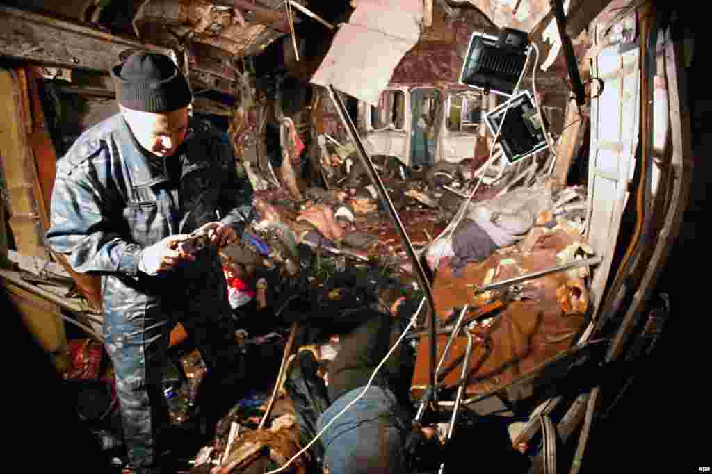 A police officer inspects the destroyed metro car. The explosion was identified as an attack by a suicide bomber.