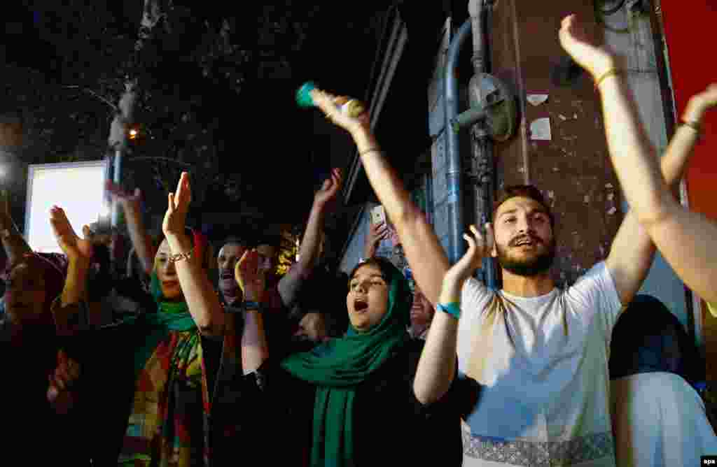 Iranians celebrate in Tehran on July 14 after officials struck a deal on limiting the country's nuclear program in exchange for the easing of sanctions.