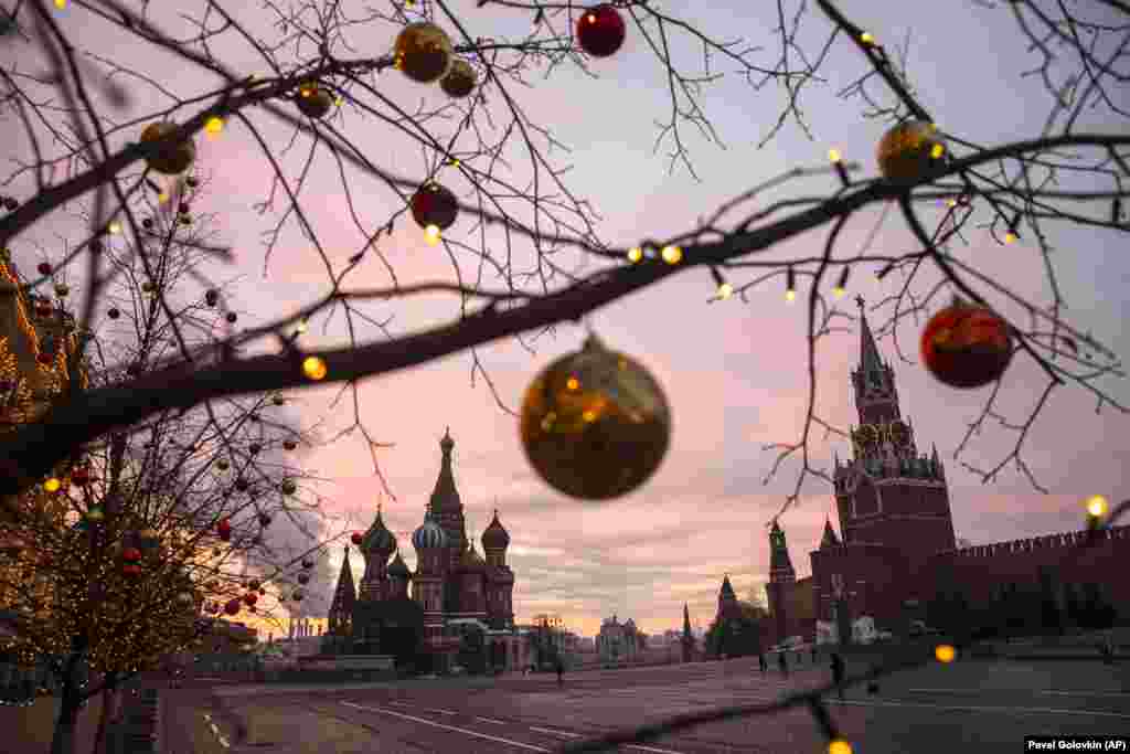 Ornaments hang from the trees as the sun rises over Moscow's Red Square on December 12. Mayor Sergei Sobyanin said there will be no massive New Year's celebrations in the city this year due to the COVID-19 pandemic.