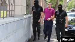 Armenia - Masked policemen escort Tigran Khachatrian, the son of Syunik Governor Surik Khachatrian, to a Yerevan court, 27Jul2015