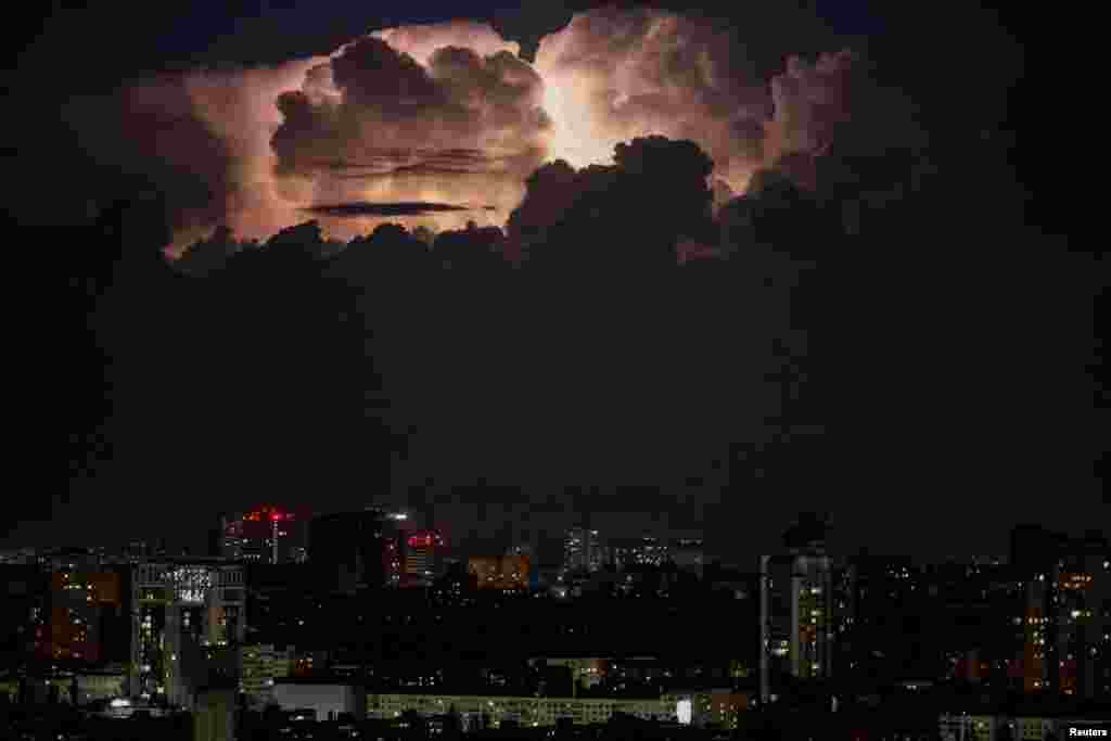 A lightning flash illuminates the sky over Kyiv before a night storm during an air raid alert in the Ukrainian capital. 