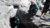 Kyrgyzstan -- Emergency team and local people continue efforts to rescue three young men buried in a collapsed illegal coal mine, Batken region, 14August2013