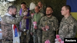Ukrainian soldiers mark Easter at a frontline location in the Donetsk region on April 20.