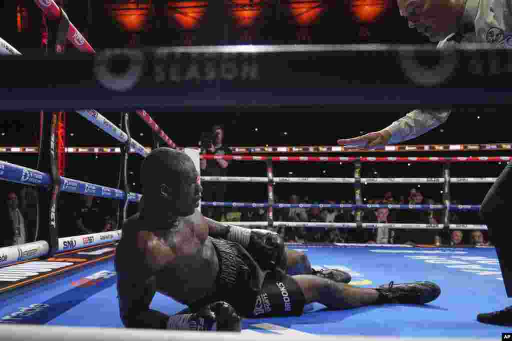 Dubois lies on the deck after Usyk landed the knockout blow during their title bout. 