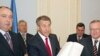 Ukraine - B. Tarasyk (R) of the Our Ukraine-Popular Self-Defense and I. Sharov (L) of the Block of the Litvin look as I. Kyrylenko (C) of the Yulia Tymoshenko Bloc shows a coalition agreement after its signing at the Ukrainian Parliament in Kyiv, 16Dec200