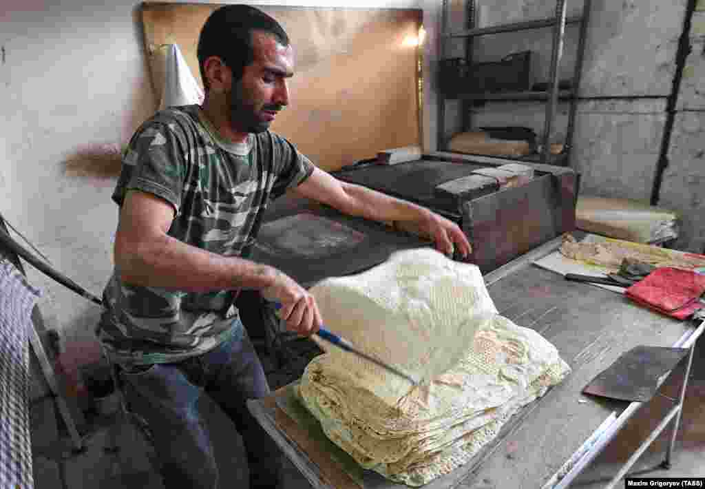 A baker in Stepanakert cooks traditional Armenian flatbread on November 25. A recently returned resident said the 2020 conflict was the worst the city had experienced, telling a Reuters reporter: "I have seen the third war already here. In 1992 and 2016 I did not leave the city for even a minute. But this time it was awful."