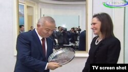 A screen grab of Uzbek President Islam Karimov meeting with the chairman of the American-Uzbek Chamber of Commerce Carolyn B. Lamm in Tashkent.