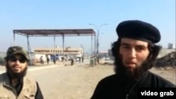A screen grab from an Islamic State recruitment video showing a Tajik national (right) identified as Abu Umariyon.