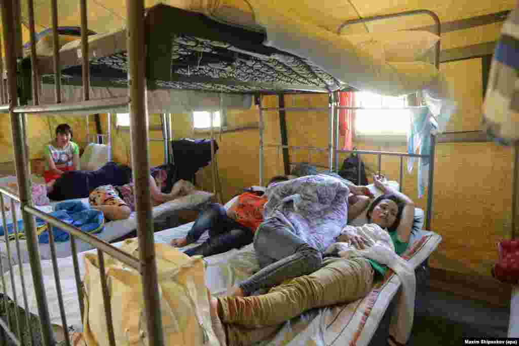 Illegal immigrants from Vietnam lie inside their tent at an immigration detention camp located in northeast Moscow in August 2013. 