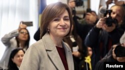 Moldovan President Maia Sandu reacts after casting her ballots in Chisinau during the country's presidential election and referendum on joining the European Union on October 20.