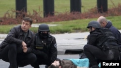 A gunman identified as Mevlik Jasarevic lies on the street after being overwhelmed after he fired shots at the U.S. Embassy in Sarajevo on October 28.