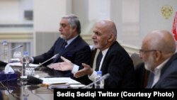 Afghan President Ashraf Ghani (center) and Chief Executive Abdullah Abdullah (left) attend a meeting in Kabul.